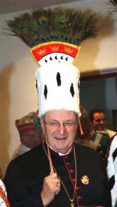 Cardinal Meisner wearing a feathered carnival hat
